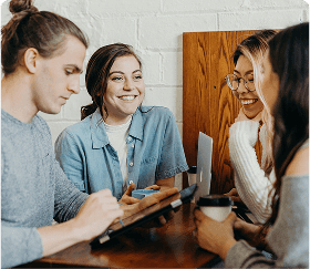 People smile while sitting at the table